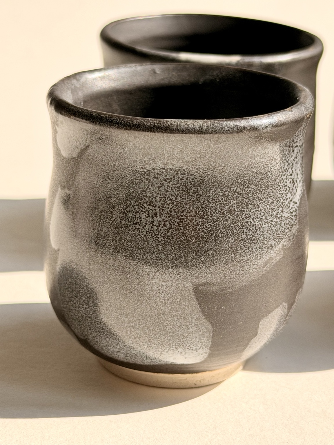 A small group of handmade ceramic cups